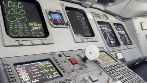 Close-view-of-a-jet-cockpit-while-copilots-selects-landing-gear-lever-down