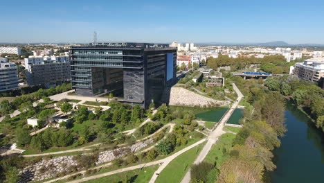 Drone-flight-towards-Montpellier-town-hall-sunny-day.-Modern-building