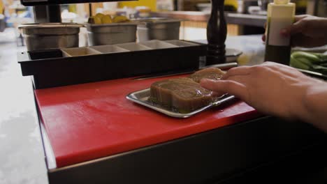 chef lubricates tuna with oil