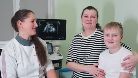 excitement fills the room as the clinical session ends, with the female radiologist smiling while conversing with her patient and the young boy, both expressing joy and satisfaction on their faces
