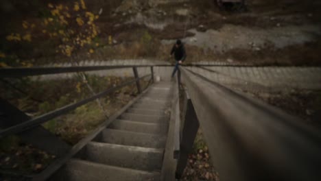 man climbing wooden stairs outdoors