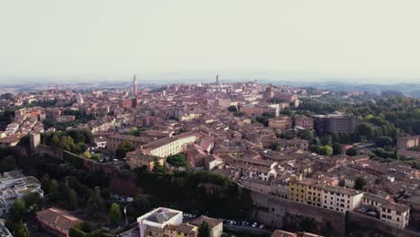 drone pulling back over siena, italy