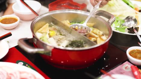 preparing hotpot with fresh ingredients in bangkok