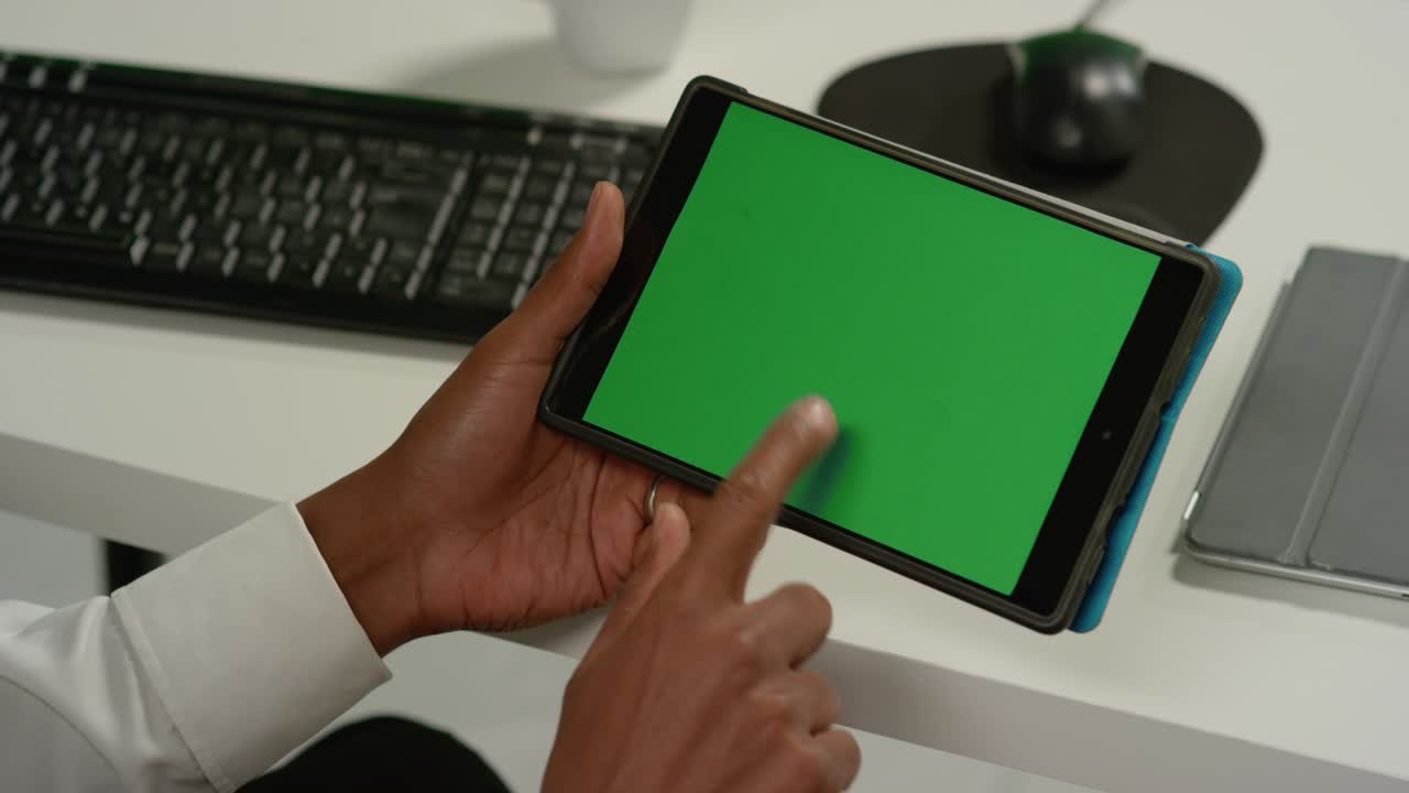 CU Man at Taps on Tablet with Green Screen