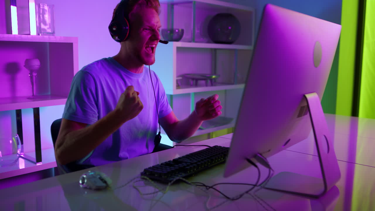 Excited player celebrating victory in tournament closeup. Neon cyberspace room