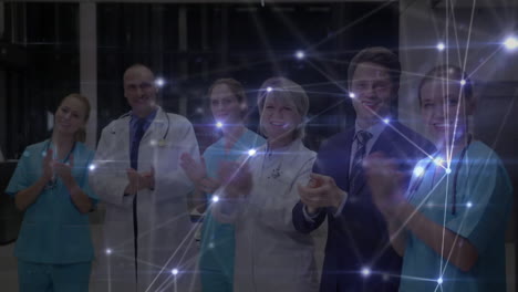 red de conexiones contra el equipo de profesionales médicos aplaudiendo en el hospital
