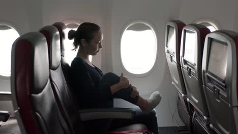 girl stretching in plane