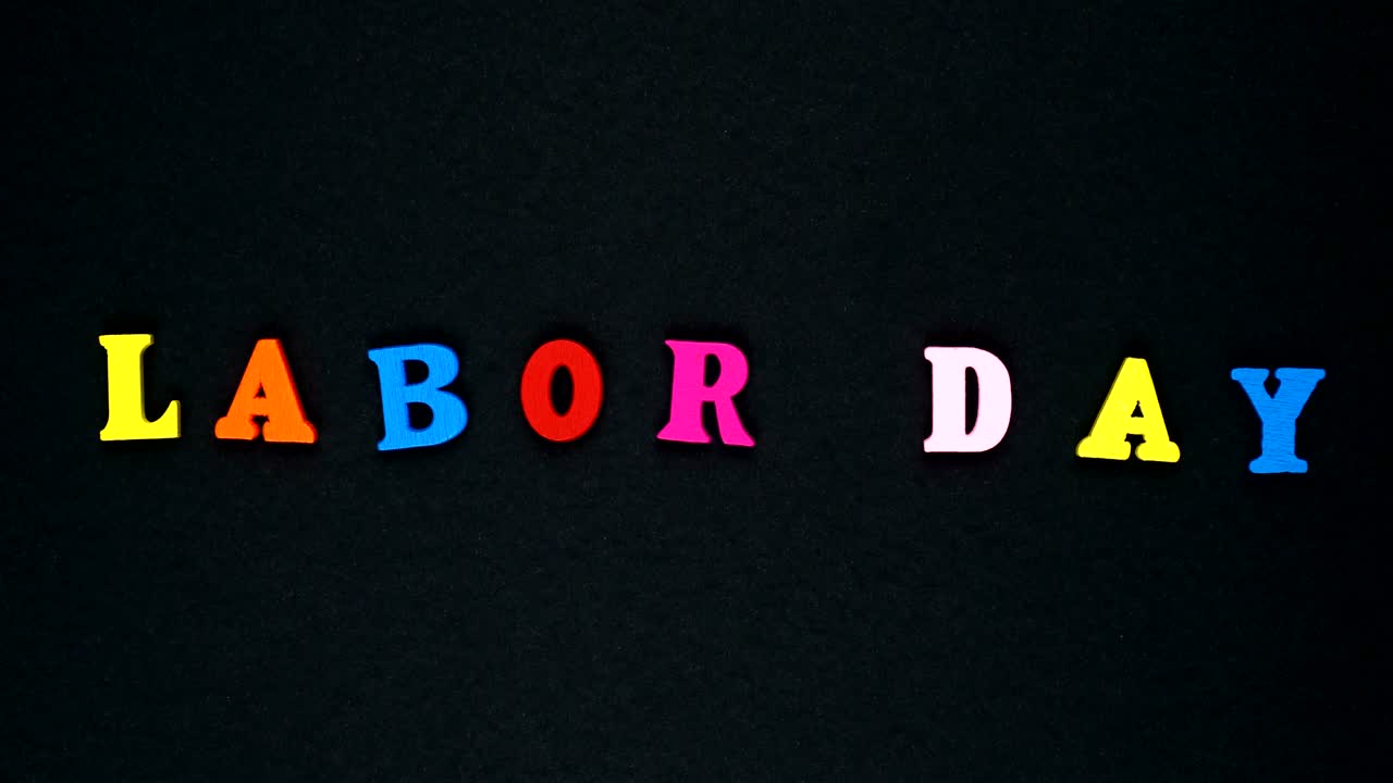 La Parola "Festa del Lavoro" Formata da Lettere di Legno Multicolori. Loop di Parole Colorate