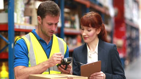 warehouse manager and delivery driver smiling at camera