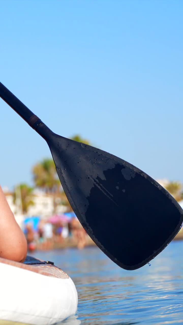 Woman Paddleboarding on the Water