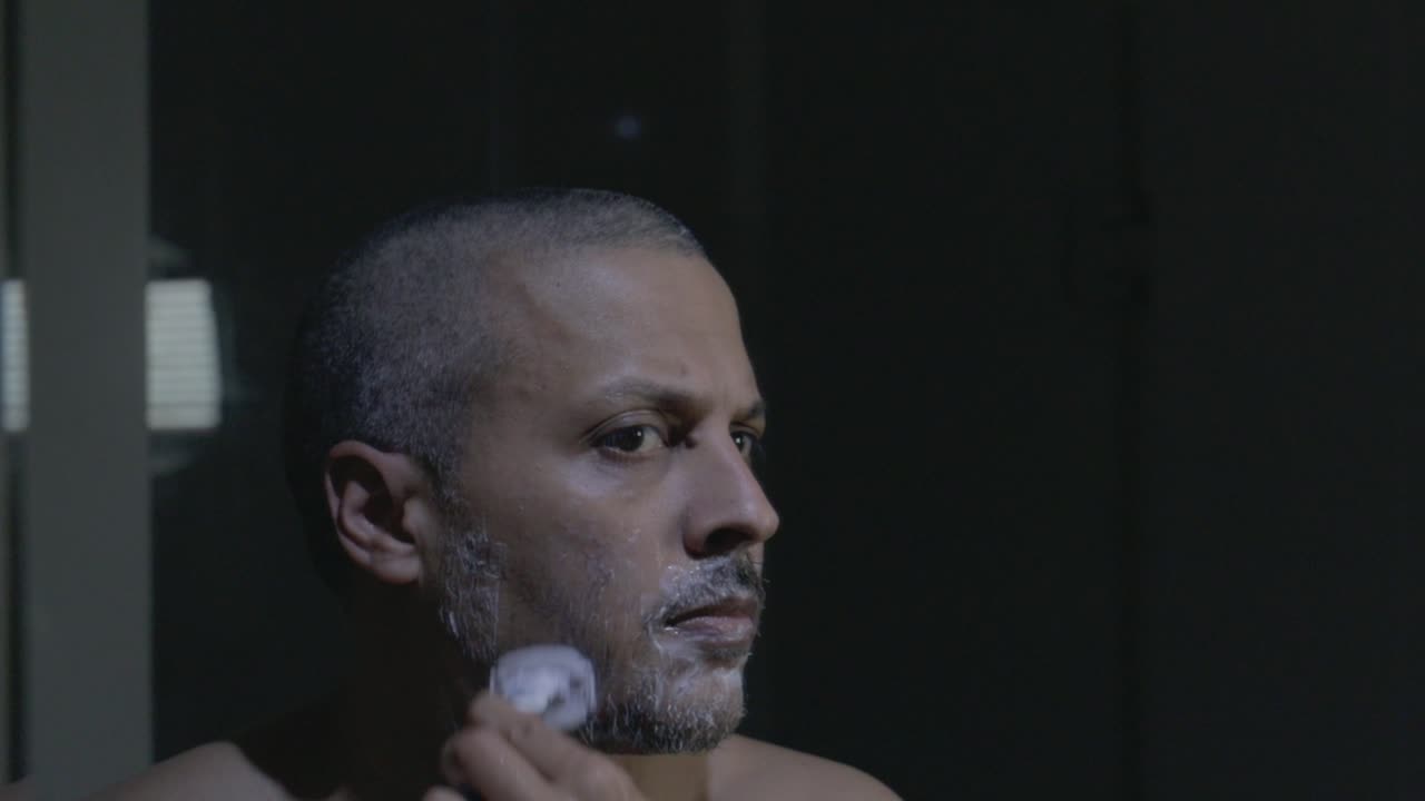 Close-up of Man Shaving His Face with Foam and Razor