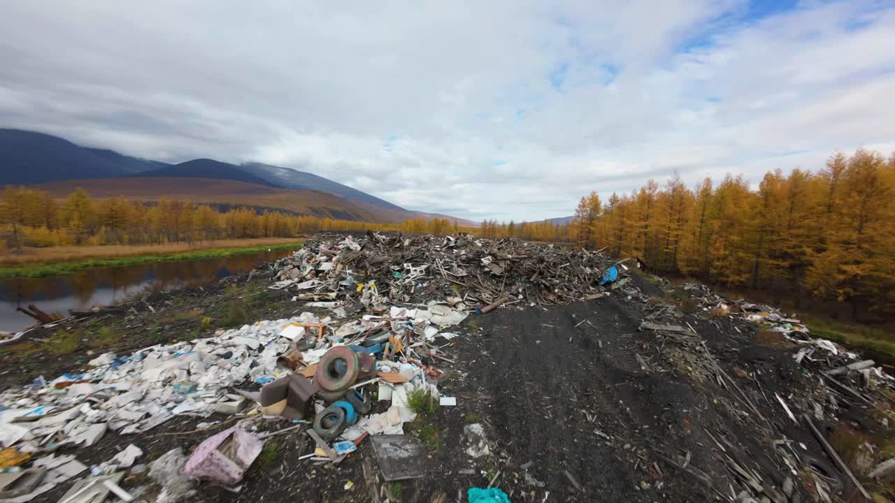 A towering pile of household trash looms above tranquil waters, framed by vibrant autumn foliage and mountains. The contrast of nature and waste highlights environmental concerns vividly.