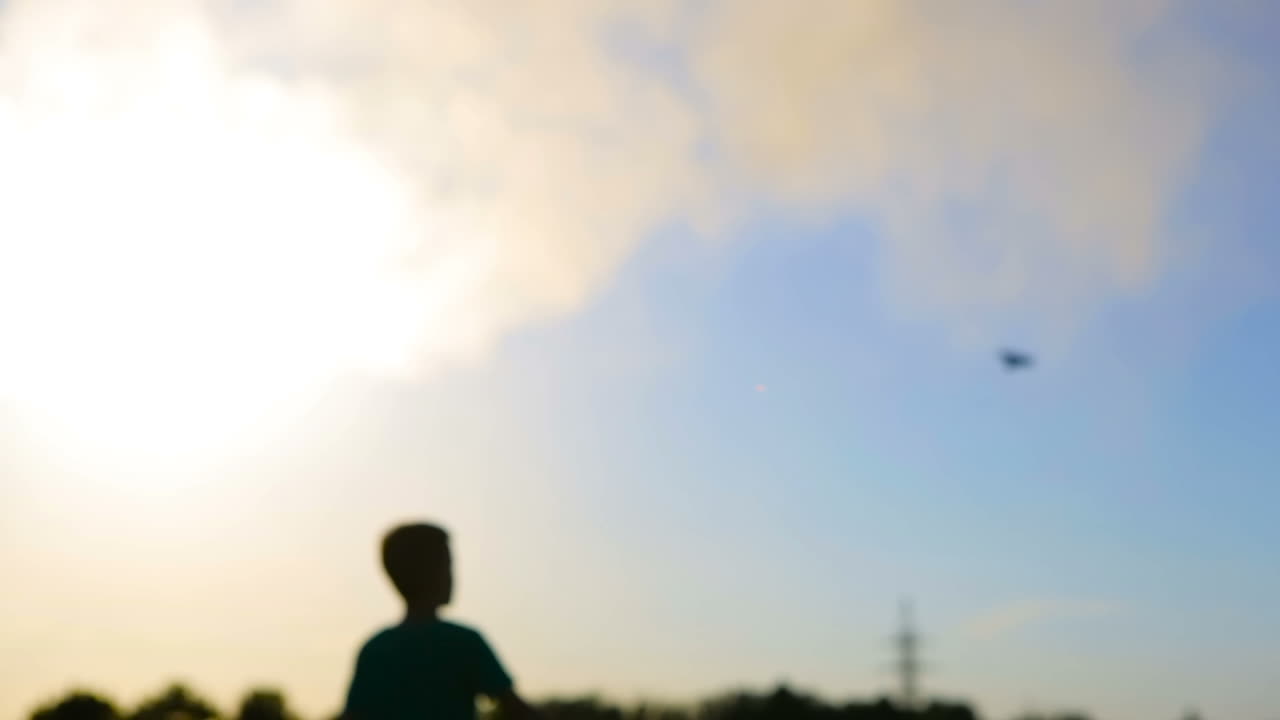 Kid Playing With Flying Paper Plane. Cute boy throwing a paper airplane into the sky in grass
