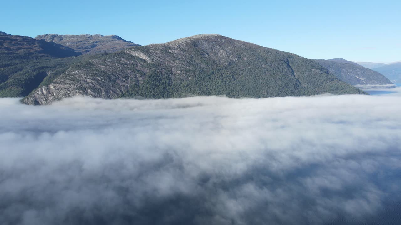 Drone footage of Hardanger fjord in Western Norway. The Fjord is covered by morning mist