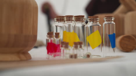 glass bottles of different sizes with corks stand on table