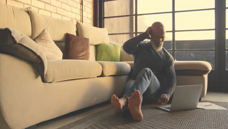 senior man using laptop in living room 4k