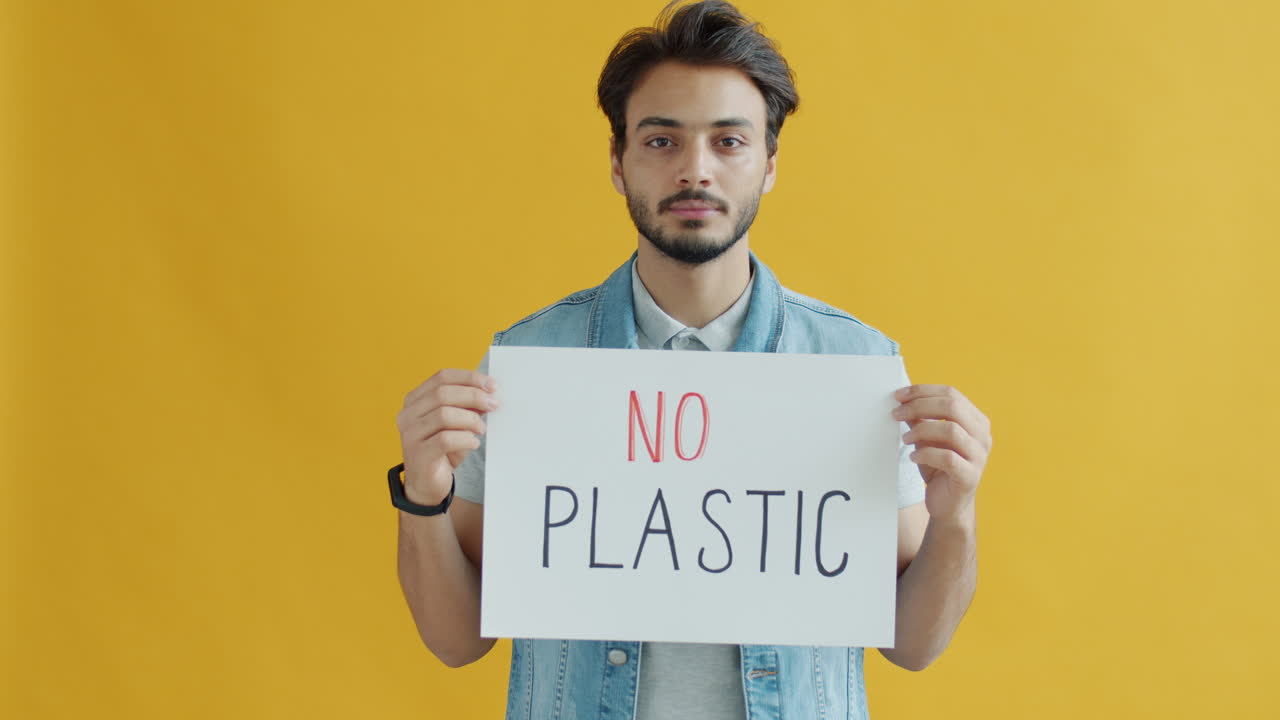 Man Holding "No Plastic" Sign