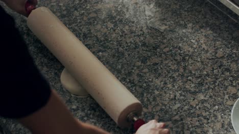 anonymous chef rolling dough for pastry