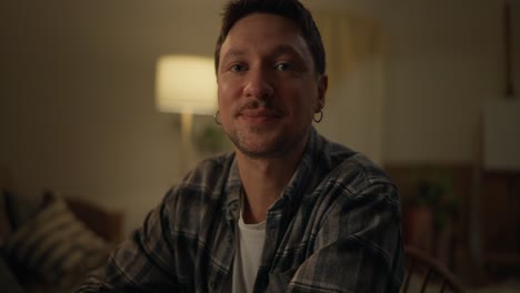 man smiling at camera in home