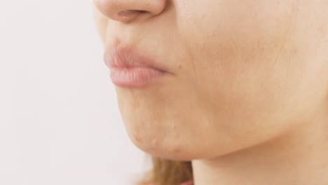 close-up portrait of woman eating cracker.