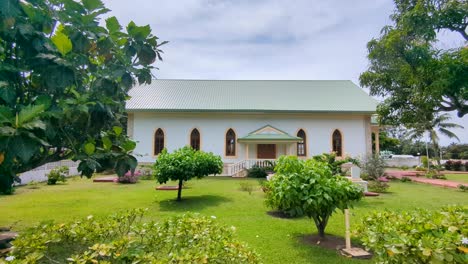 quaint architecture church building with beautiful gardens on tropical island in french polynesia