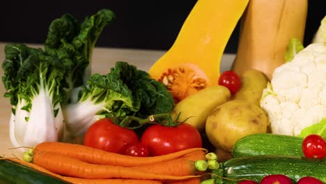 assorted vegetables arranged against a black background