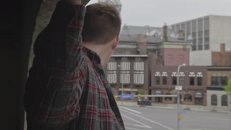 caucasian male looking out into the city