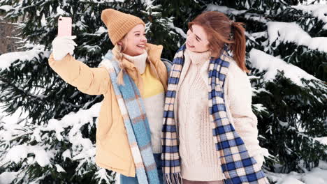 two girls taking a selfie in the snow