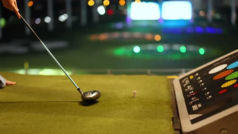 night golf practice at an indoor driving range