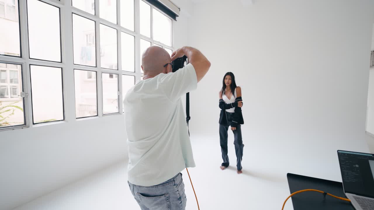 Fashion shoot in a studio with a model and a photographer