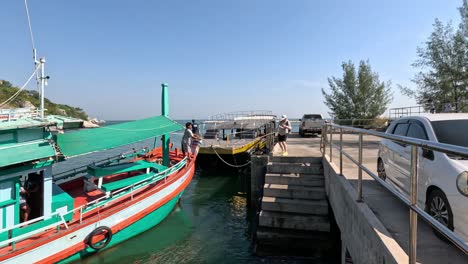 a boat approaches and docks at a pier over time.