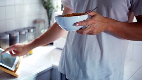 woman using digital tablet while having breakfast