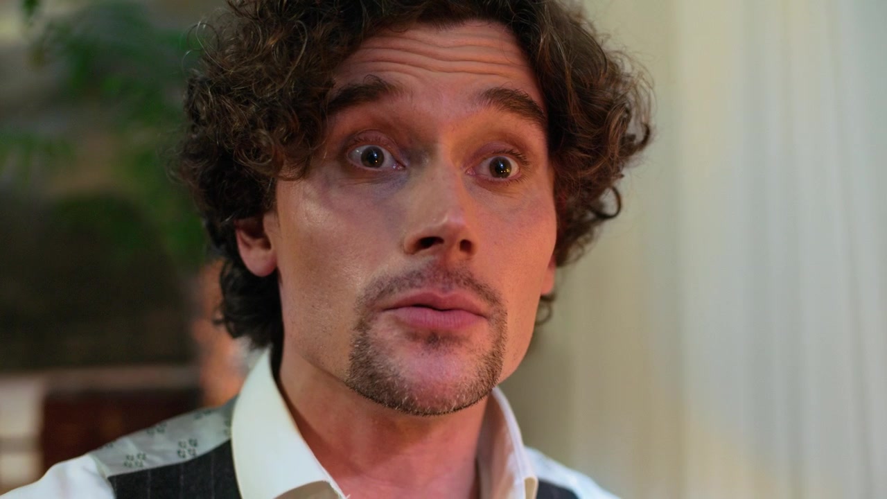 Close-up of an Expressive Man with Curly Hair Talking and Gesturing
