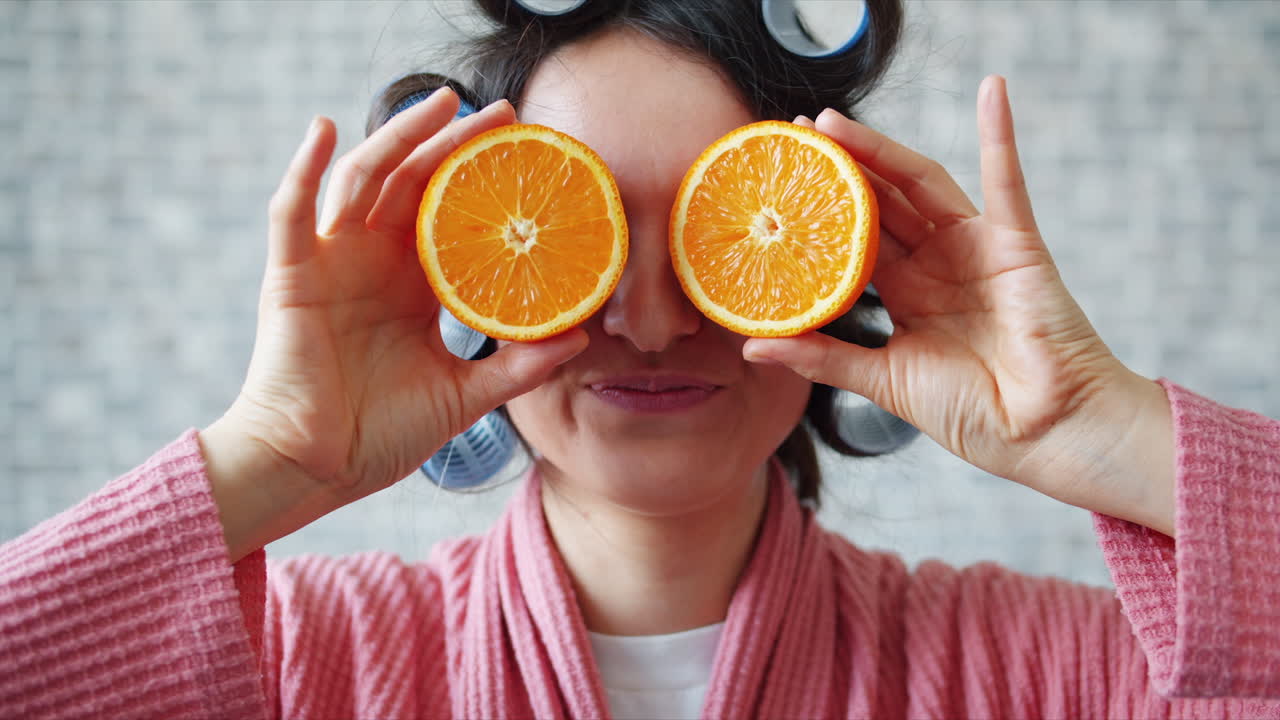 Woman with Orange Slices and Hair Curlers