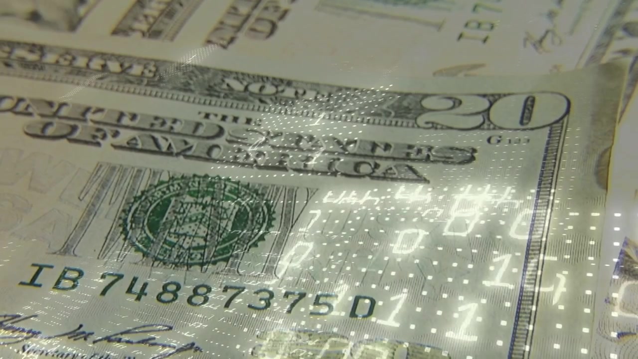 Dotted LED sweeping light, camera panning over stacked 20s, revealing serial and portrait to verify