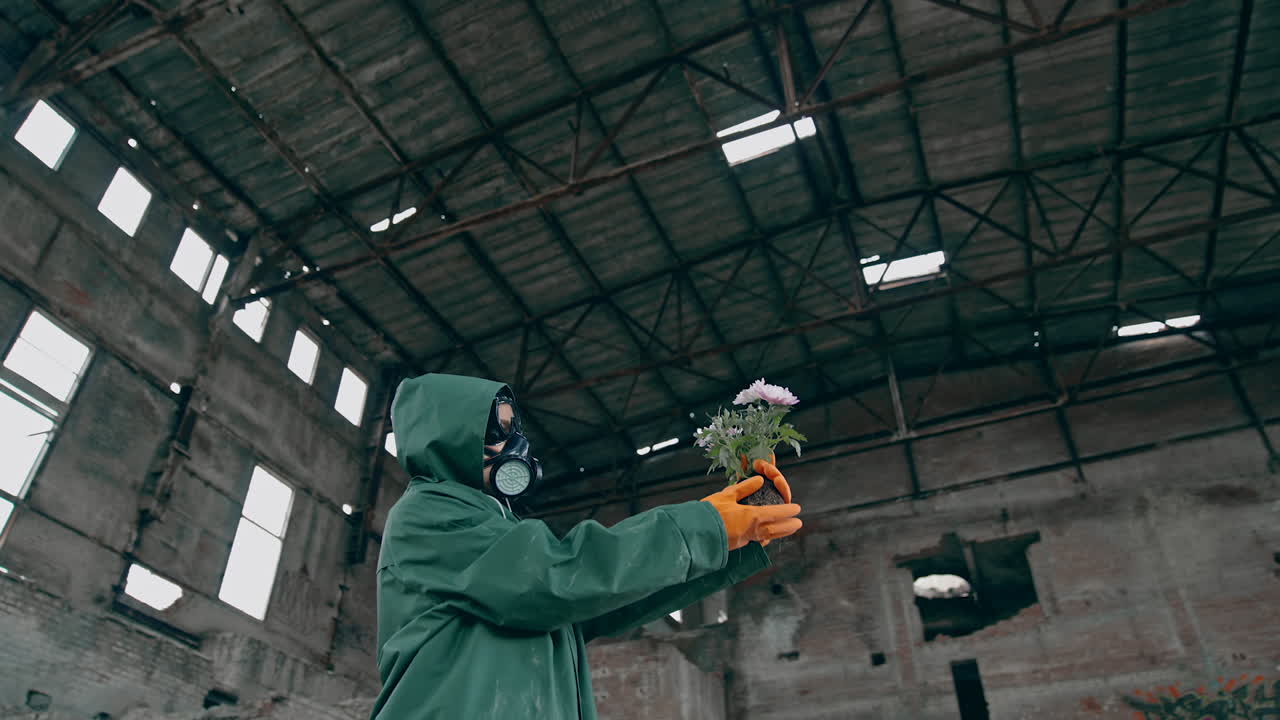 Man in ruined industrial building. Man wearing gas masks after nuclear disaster