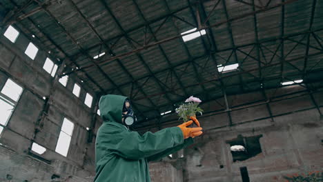 man in ruined industrial building. man wearing gas masks after nuclear disaster