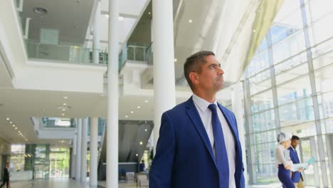 caucasian businessman walking in the lobby at office 4k