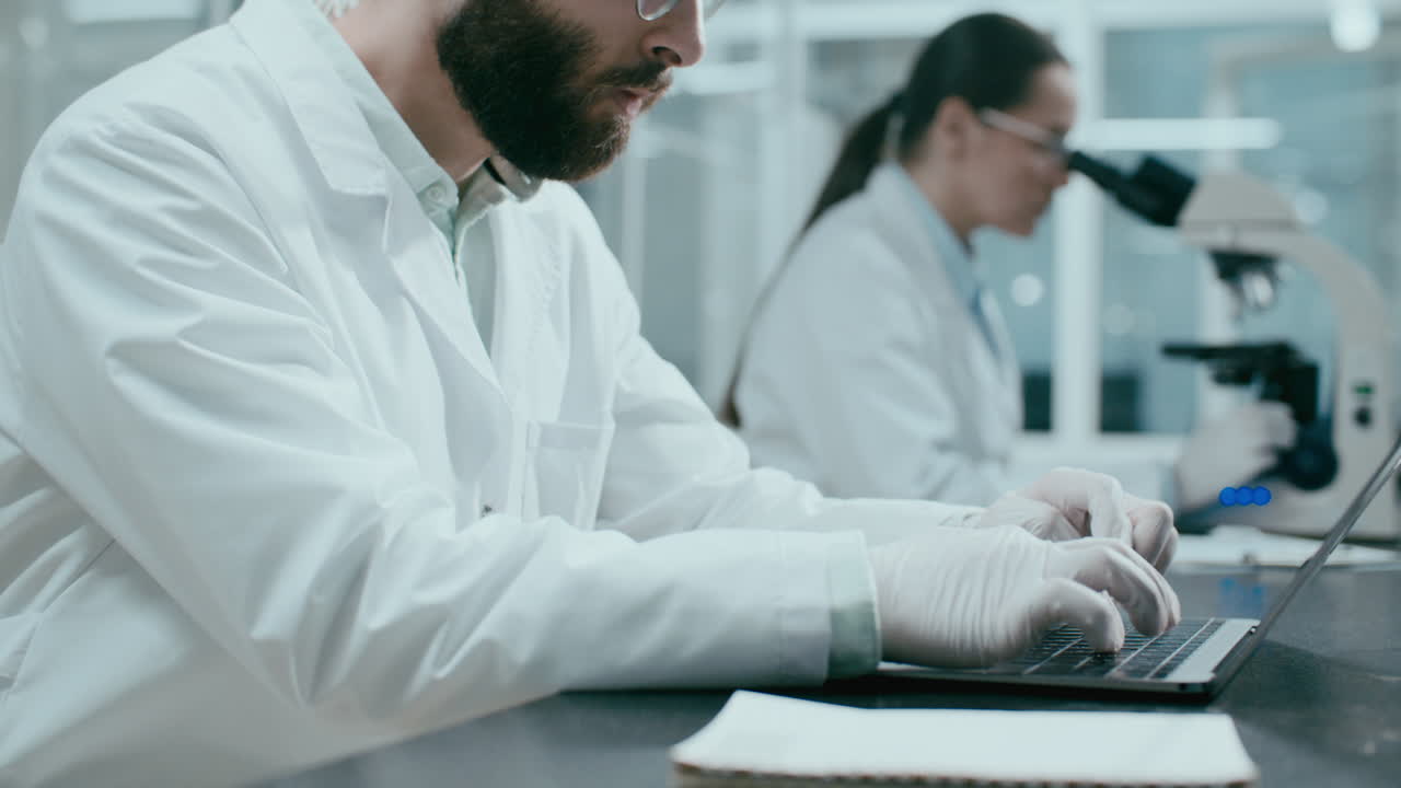 Close Up of Scientist Using Laptop during Laboratory Research