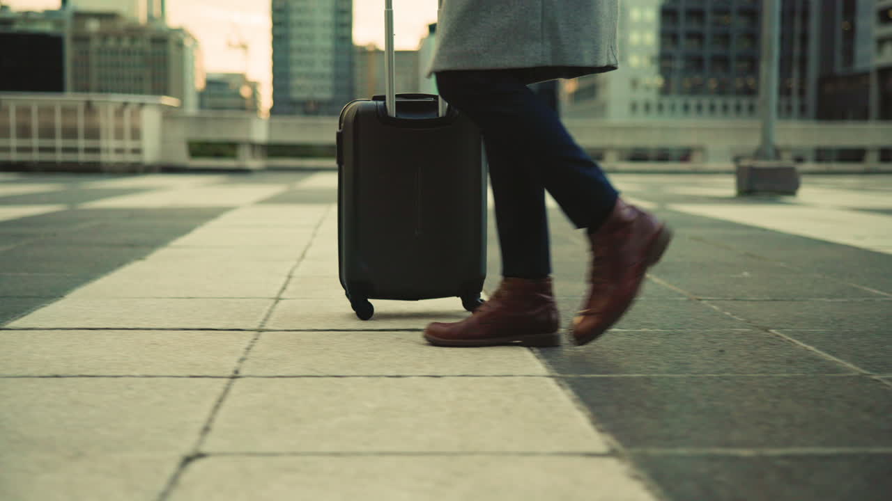 Person walking with suitcase in city