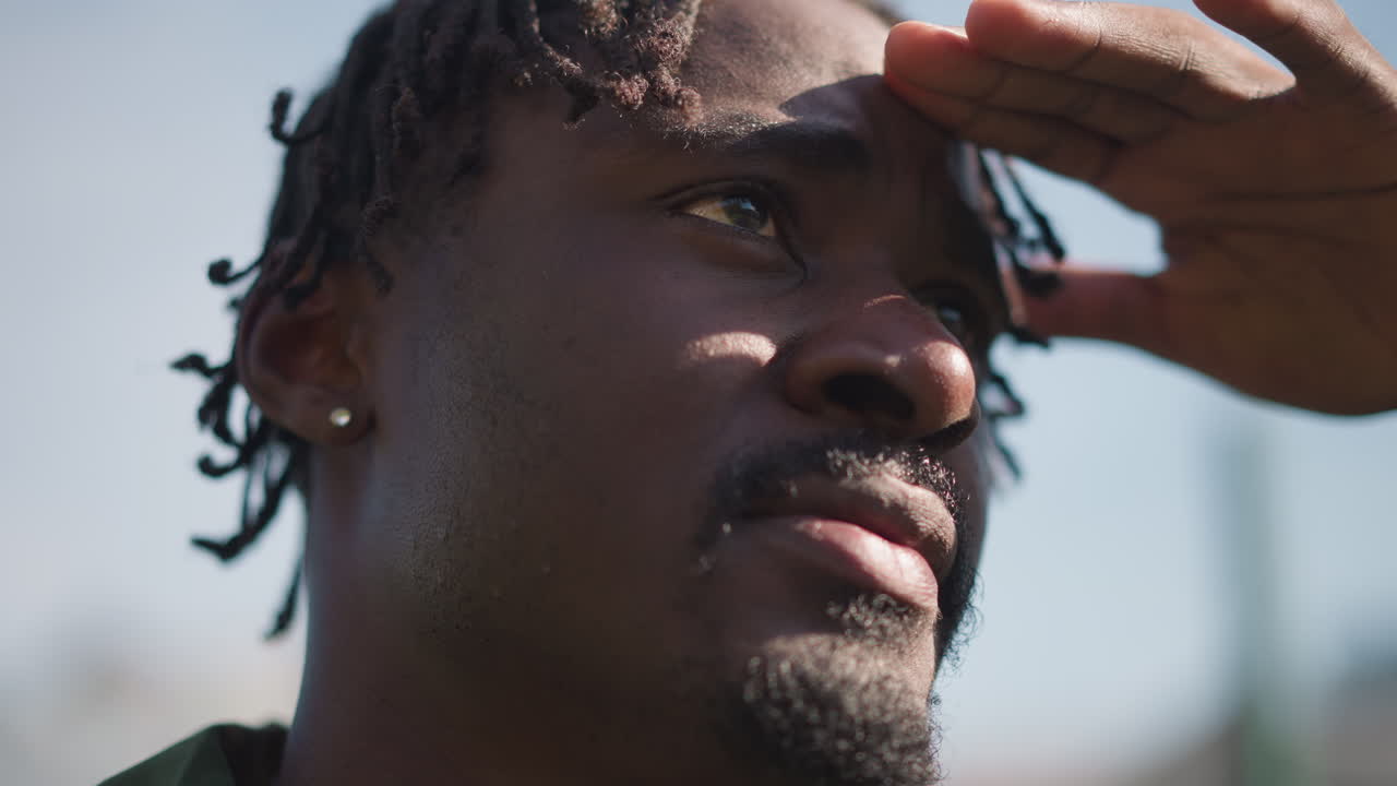 Vigilant Person Viewing Distant Scenery, Alert Scout Diligently Observing Wide Expansive Landscape Area, Vigilant Figure With Hand Over Eye Scrutinizing Distant Landscape For Signs Or Movement