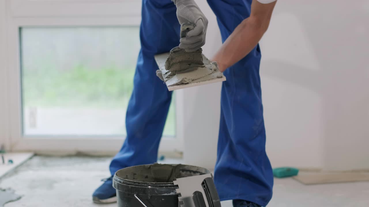 Installing ceramic floor tiles - measuring and cutting the pieces. Construction, renovation, repair apartment. Cuts tile. Tile cutting