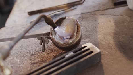 close up of melting metal with blowtorch in studio in slow motion