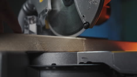 slow motion close up of table saw cutting wood on construction site