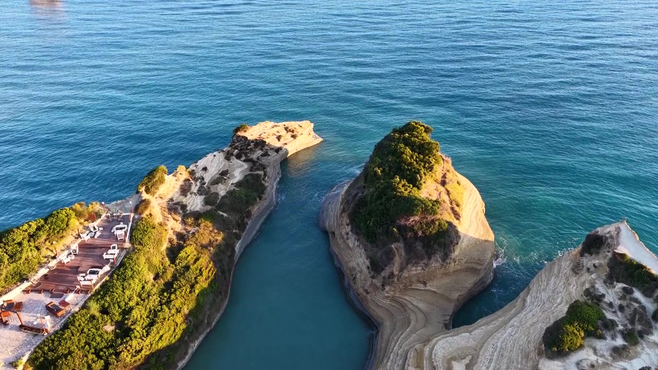 Top down aerial drone shot over the narrow channel and unique sandstone rock formations of Canal d'Amour in Sidari, Corfu, Greece