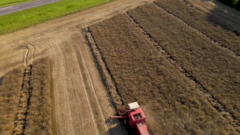 birds eye view of a combine harvester at work in a polish barley field