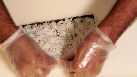 lining rice to make delicious kabuki sushi roll - close up slow motion