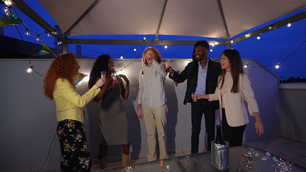 People celebrating on a rooftop at night