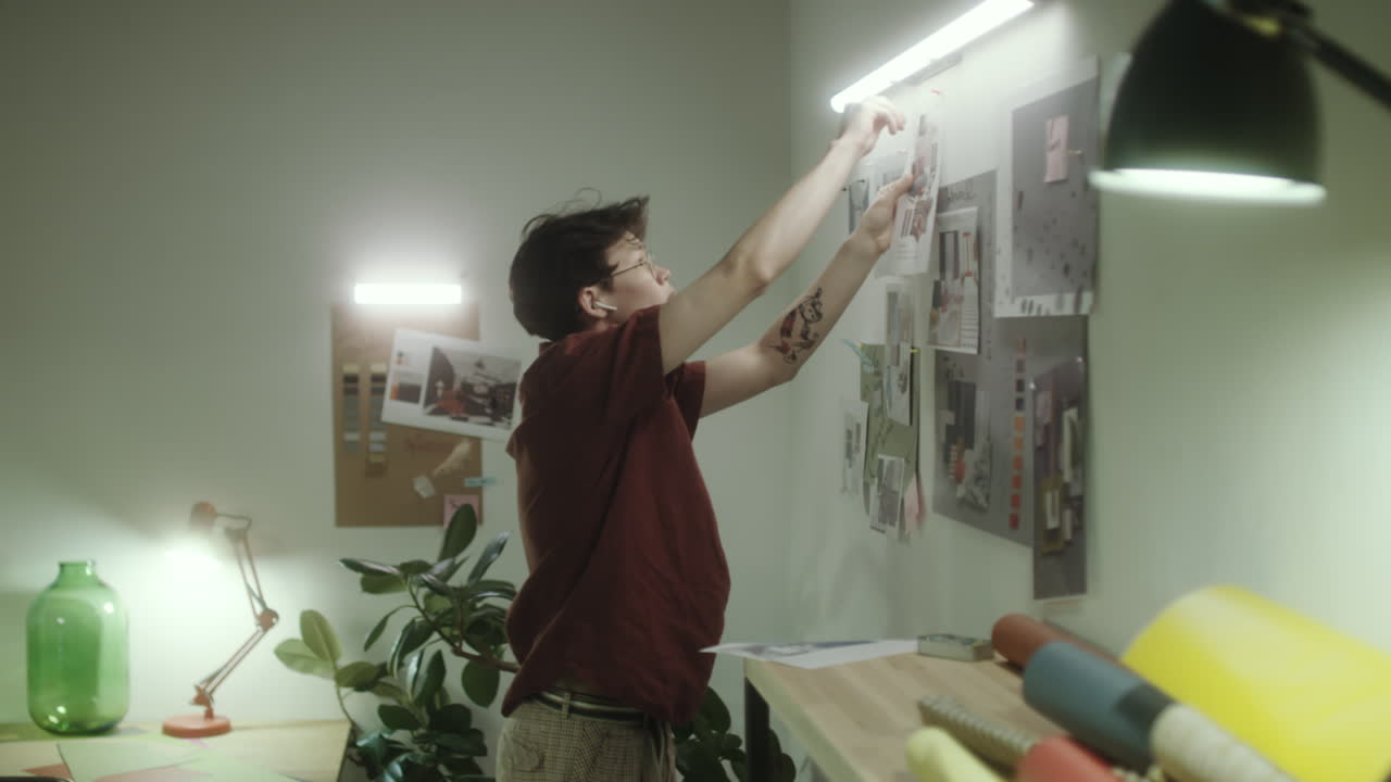 Designer Arranging a Mood Board in a Creative Studio