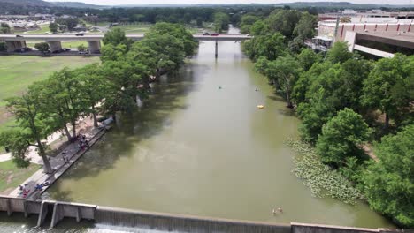 Static-aerial-footage-of-people-swimming-in-the-Guadalupe-River-in-Kerrville-Texas